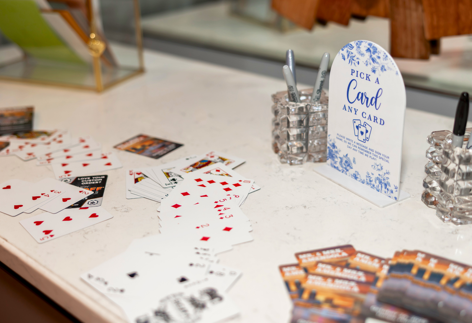 Playing cards on a table with a card selection guide and decorative items.